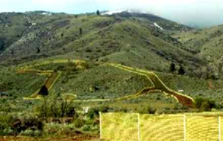 Switchback sections of track cut across the hillside and marked out with course tape.